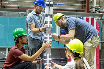 20241114-newsletter-flexwec-sm People work on a flexible wave energy converter device